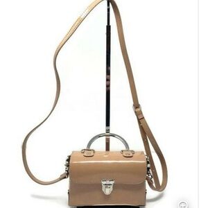 Patent nude crossbody bag.